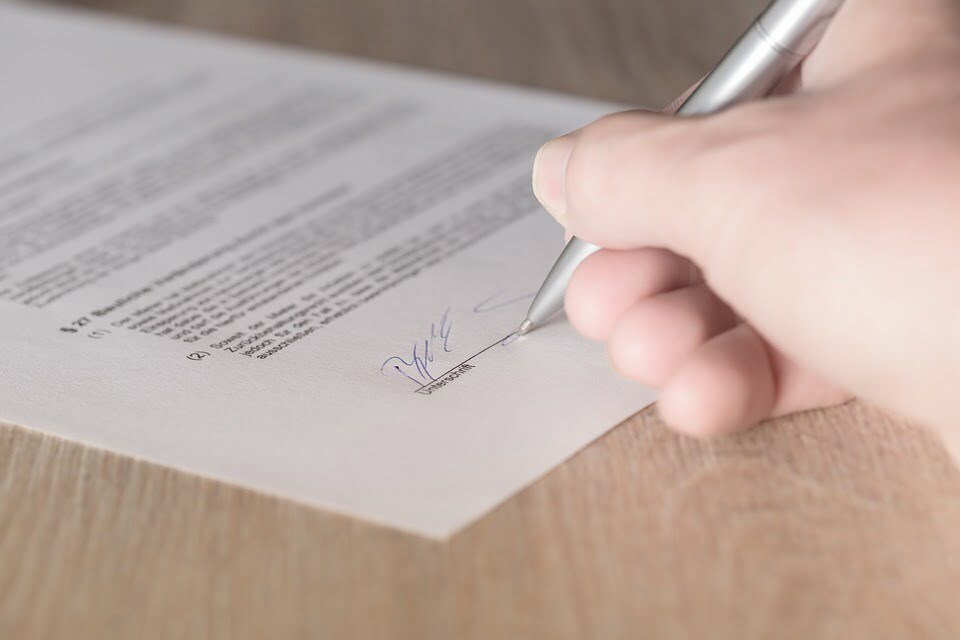 close up of man signing a document 2